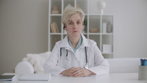 telemedicine-session-with-aged-woman-therapist-pediatrician-or-virologist-doctor-is-talking-to-camera-like-in-videochat-or-videocall